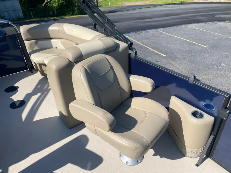 Slide: The Image of 2022 SunChaser Geneva 22 LR DH boat interior with beige seating and cup holder. - 11