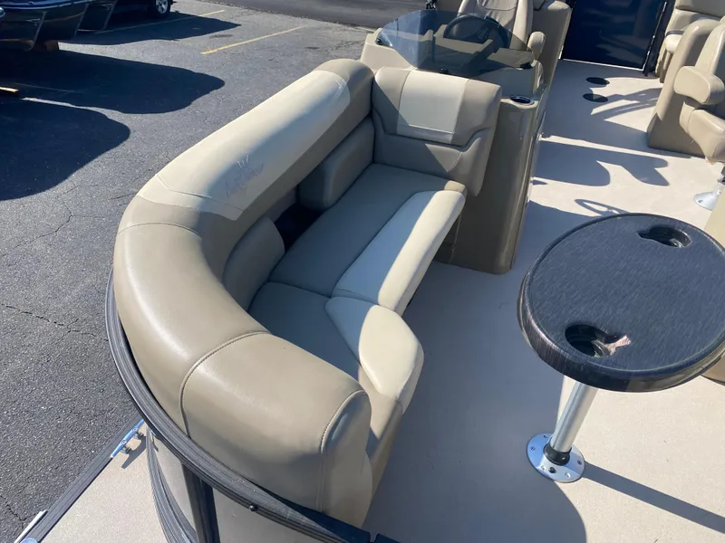 Slide: The Image of 2022 SunChaser Geneva 22 LR DH pontoon boat with beige seating and table. - 12