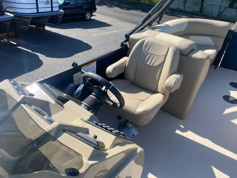 Slide: The Image of 2022 SunChaser Geneva 22 LR DH boat interior with captain's chair and steering console. - 13