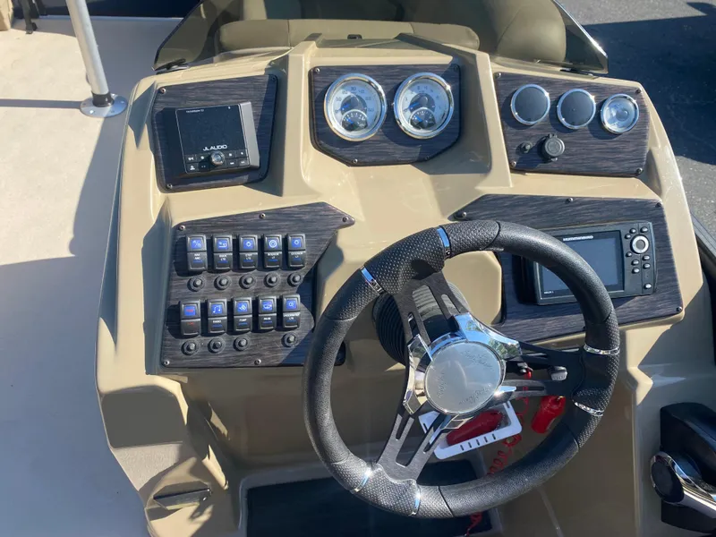 Slide: The Image of 2022 SunChaser Geneva 22 LR DH boat dashboard with steering wheel and control panel. - 16