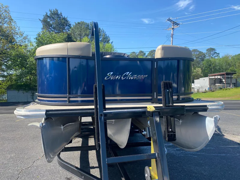 Slide: The Image of 2022 SunChaser Geneva 22 LR DH pontoon boat on trailer, blue exterior. - 4