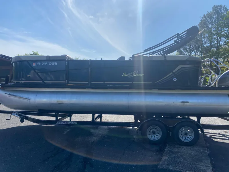 Slide: The Image of 2022 SunChaser Geneva 22 LR DH pontoon boat on a trailer in a parking lot. - 6