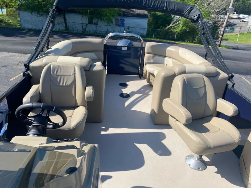 Slide: The Image of 2022 SunChaser Geneva 22 LR DH pontoon boat with beige seating and steering console. - 9