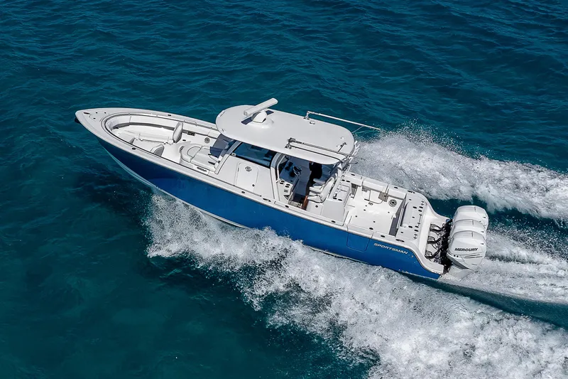 Slide: The Image of 2023 Sportsman Open 352 Center Console boat cruising on clear blue water. - 0