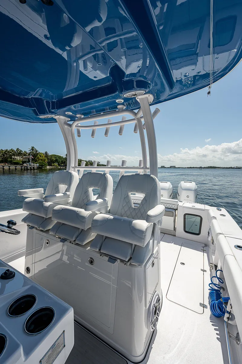 Slide: The Image of 2023 Sportsman Open 352 Center Console boat interior with seating and ocean view. - 11