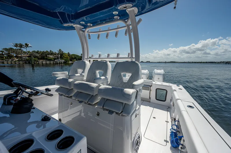 Slide: The Image of 2023 Sportsman Open 352 Center Console boat interior with seating and ocean view. - 12