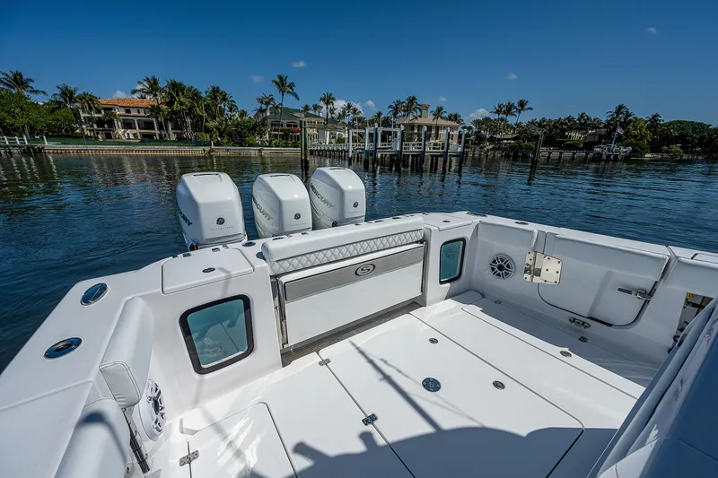 Slide: The Image of 2023 Sportsman Open 352 Center Console boat with triple outboard engines. - 21
