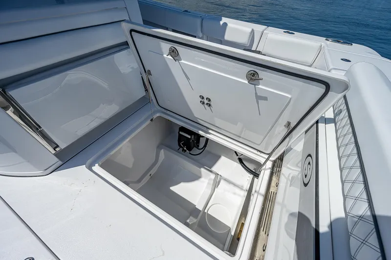 Slide: The Image of 2023 Sportsman Open 352 Center Console storage compartment open. - 22