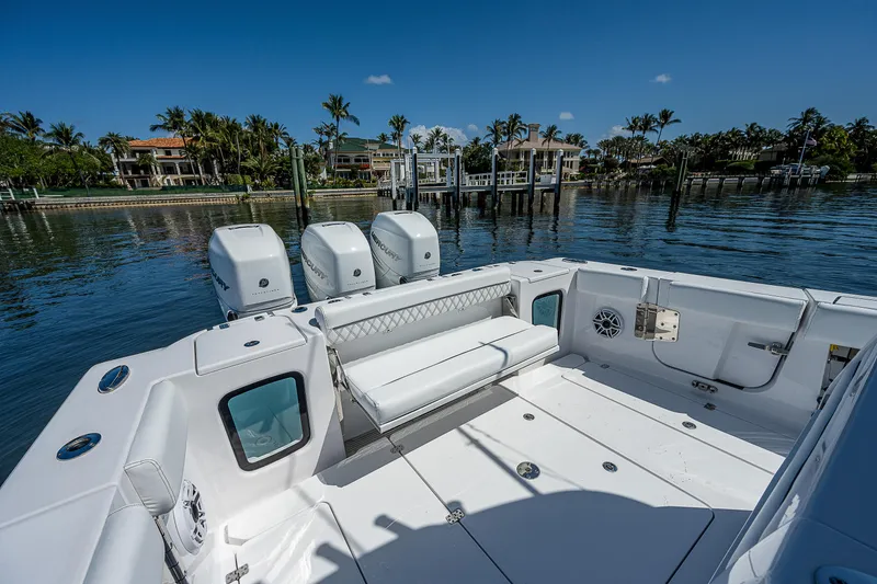 Slide: The Image of 2023 Sportsman Open 352 Center Console boat docked by waterfront homes. - 23