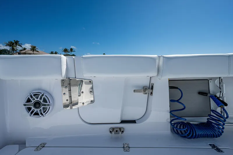 Slide: The Image of 2023 Sportsman Open 352 Center Console boat interior with speaker and coiled hose. - 24