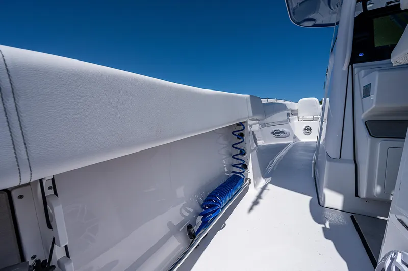 Slide: The Image of 2023 Sportsman Open 352 Center Console boat interior, white deck and storage compartments. - 25
