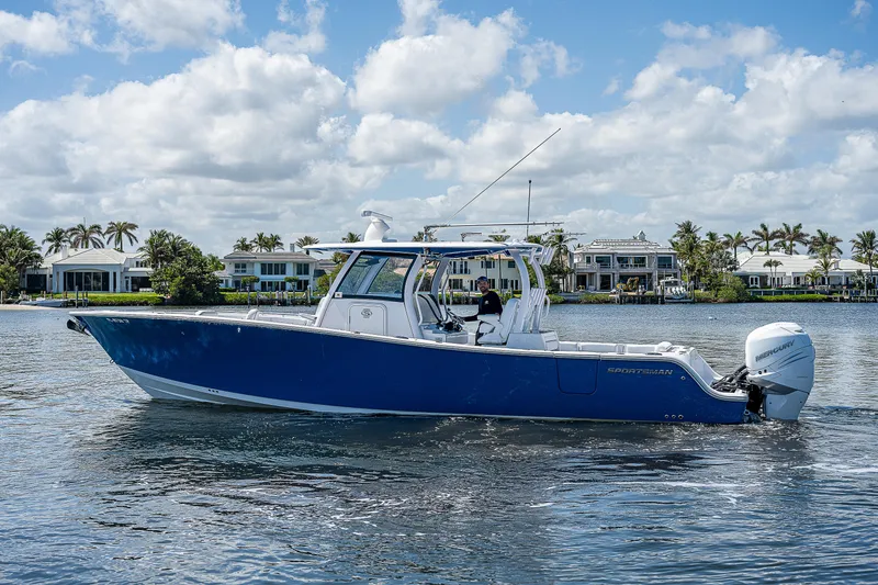 Slide: The Image of 2023 Sportsman Open 352 Center Console boat on water with waterfront homes in background. - 28