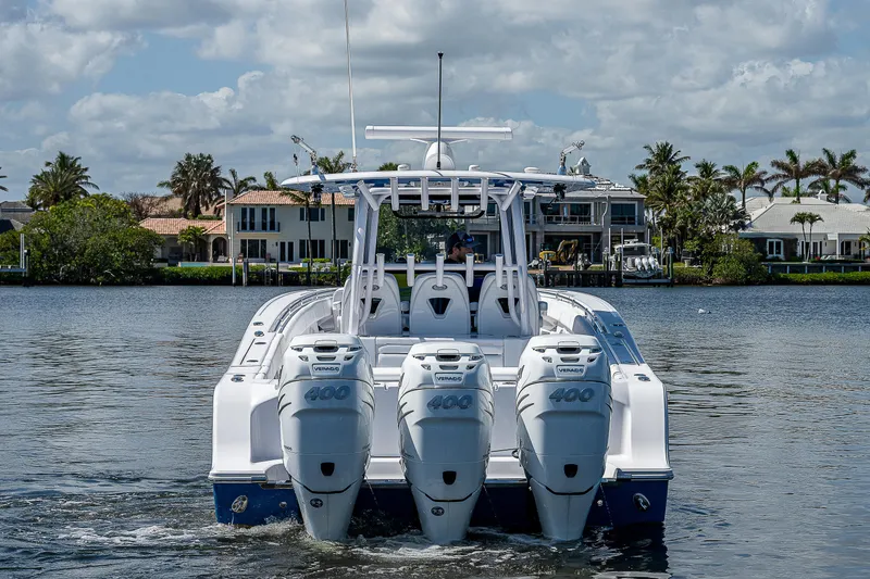 Slide: The Image of 2023 Sportsman Open 352 Center Console boat with triple engines on water. - 3