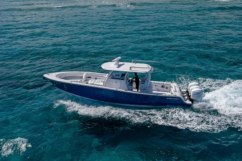 Slide: The Image of 2023 Sportsman Open 352 Center Console boat cruising on clear blue water. - 31