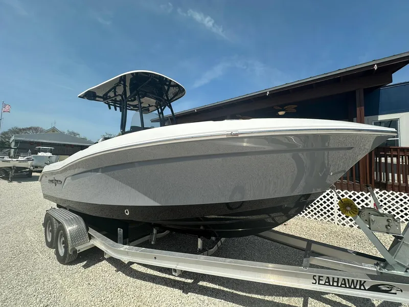 Slide: The Image of 2024 NauticStar 222 OSL boat on a Seahawk trailer, displayed outdoors. - 1