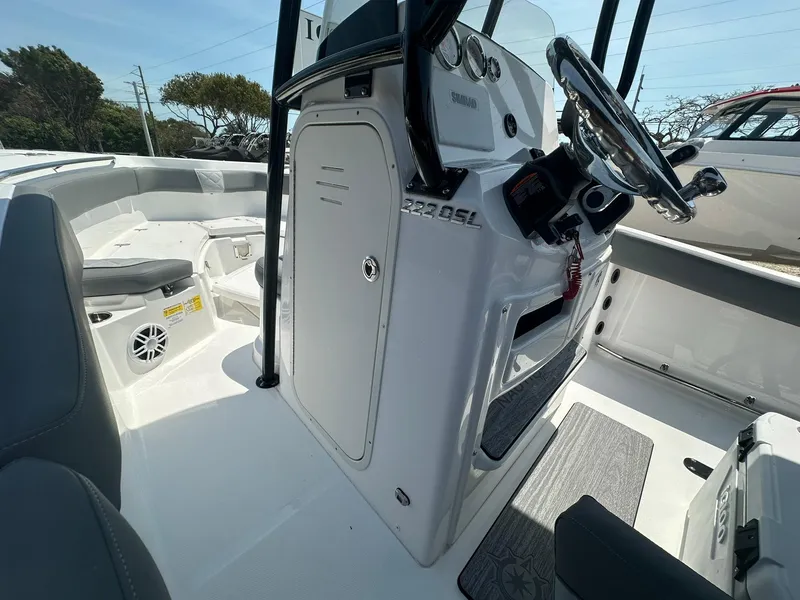 Slide: The Image of 2024 NauticStar 222 OSL boat interior with steering console and seating. - 13