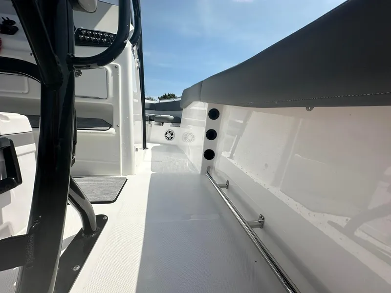 Slide: The Image of 2024 NauticStar 222 OSL boat interior with sleek white deck and black accents. - 15