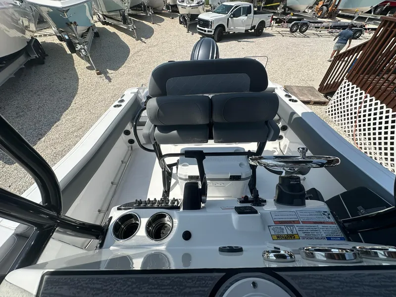 Slide: The Image of 2024 NauticStar 222 OSL boat interior with dual seats and control panel. - 16