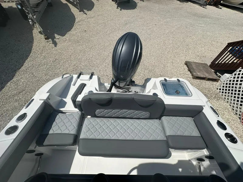 Slide: The Image of 2024 NauticStar 222 OSL boat with cushioned seating and outboard motor. - 17