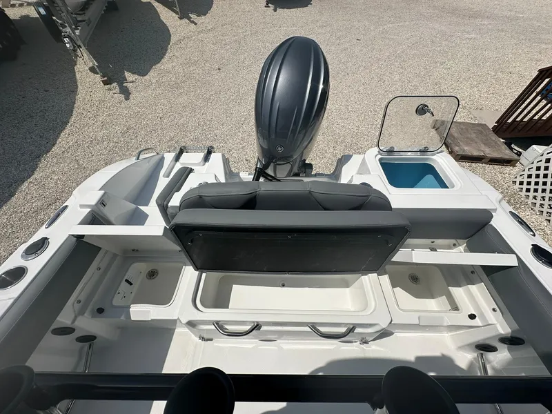 Slide: The Image of 2024 NauticStar 222 OSL boat interior with motor and seating. - 18