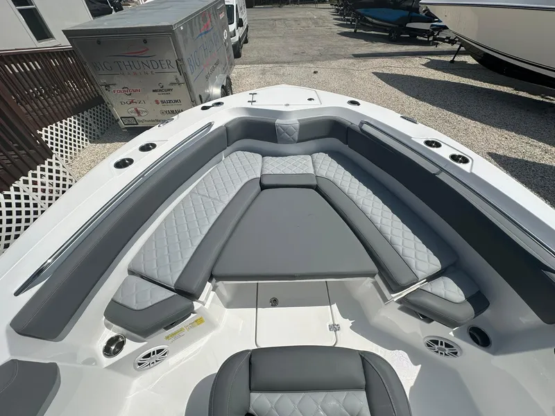 Slide: The Image of 2024 NauticStar 222 OSL boat interior with cushioned seating and storage compartments. - 4