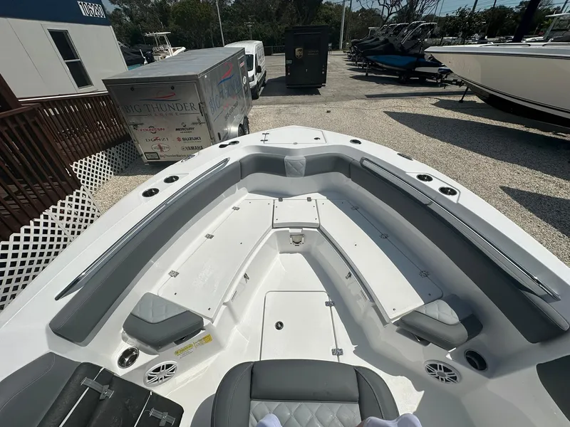 Slide: The Image of 2024 NauticStar 222 OSL boat interior with seating and storage compartments. - 6