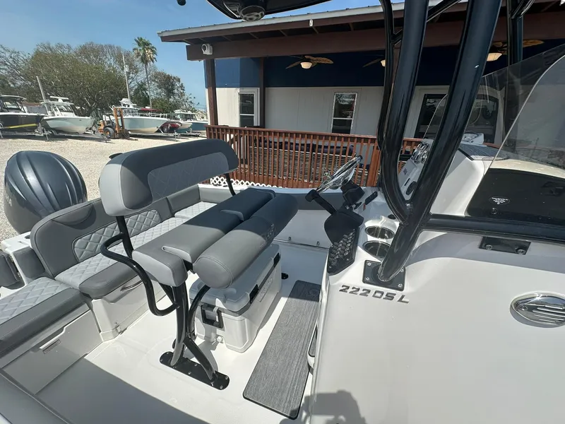 Slide: The Image of 2024 NauticStar 222 OSL boat interior with seating and console. - 8