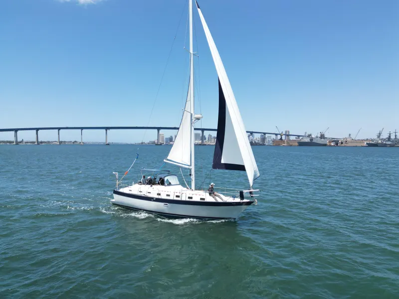 Slide: The Image of Sailboat Lancer 40 (1983) cruising near a bridge on a sunny day. - 14