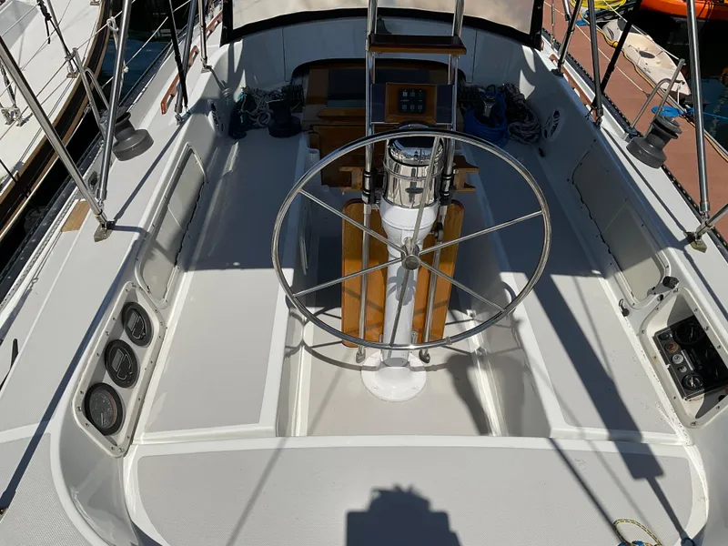 Slide: The Image of 1983 Lancer 40 sailboat cockpit with steering wheel and navigation instruments. - 7