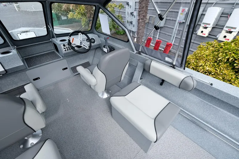 Slide: The Image of 2024 KingFisher 1825 Falcon boat interior with modern seating and steering console. - 10