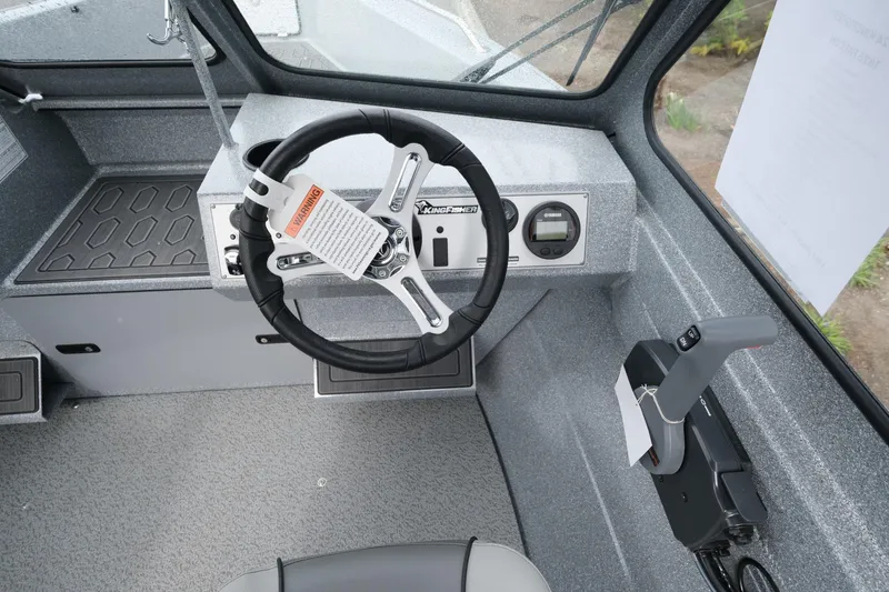 Slide: The Image of 2024 KingFisher 1825 Falcon boat interior with steering wheel and controls. - 12