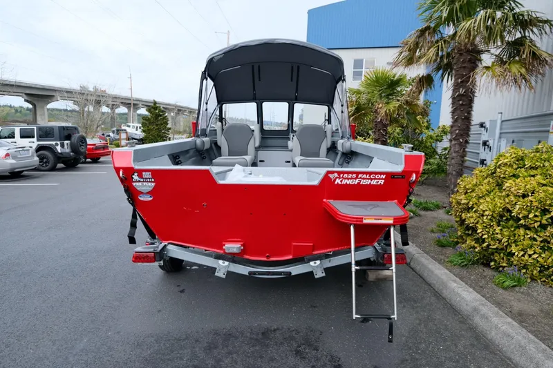 Slide: The Image of 2024 KingFisher 1825 Falcon boat, red exterior, parked outdoors near palm trees. - 4