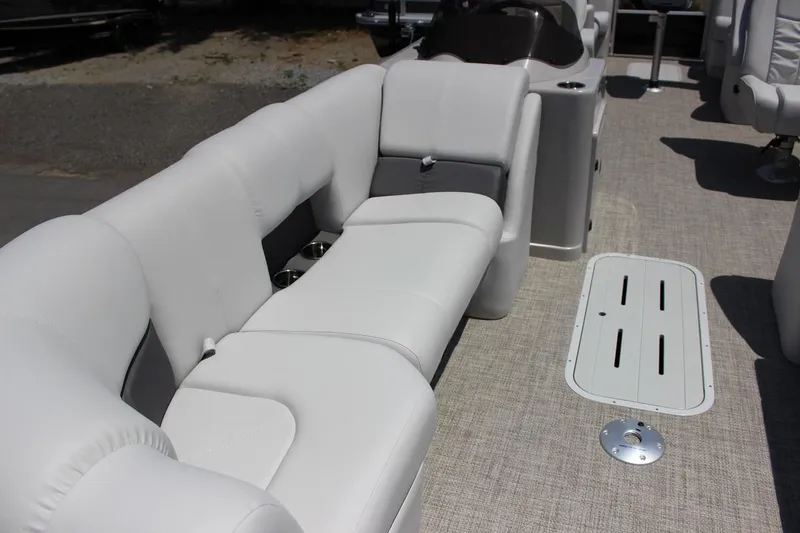 Slide: The Image of 2023 SunCatcher Fusion 324 RC pontoon boat interior with plush seating and deck storage. - 4