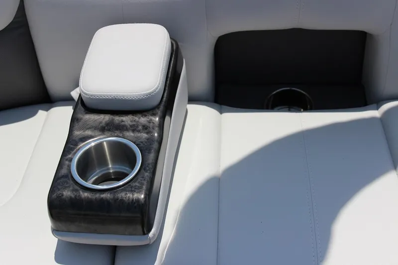 Slide: The Image of 2023 SunCatcher Fusion 324 RC boat interior with cup holder and armrest. - 8