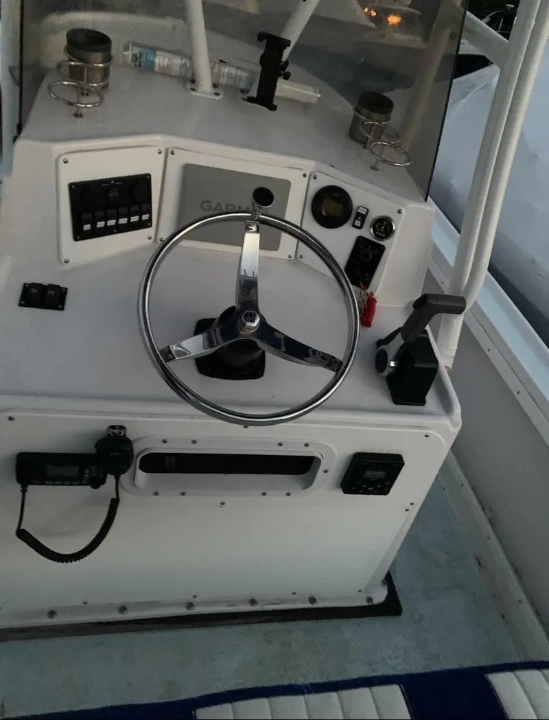 Slide: The Image of 1980 Mako 23 boat dashboard with steering wheel and controls. - 10
