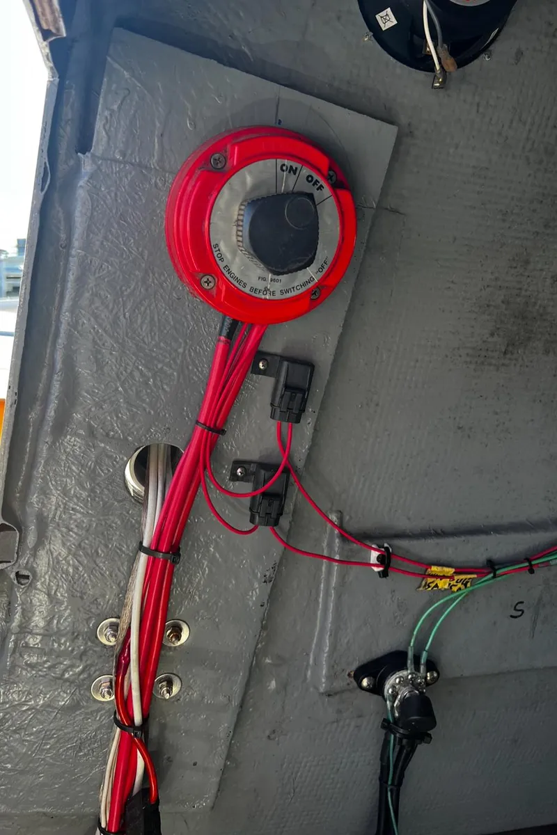 Slide: The Image of 1980 Mako 23 boat electrical panel with red wiring and switch. - 13