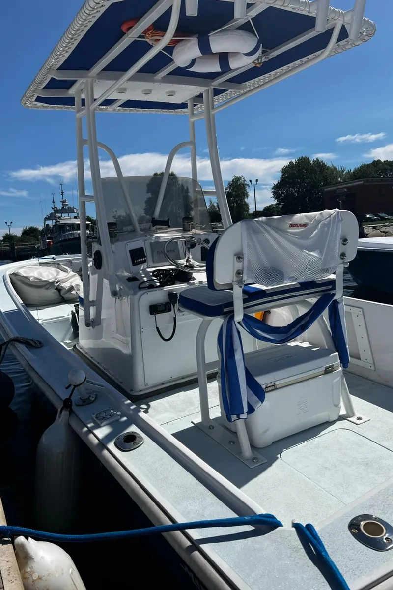 Slide: The Image of 1980 Mako 23 boat with T-top, docked under clear blue sky. - 8