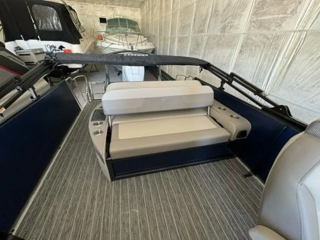 Slide: The Image of 2024 Premier 250 Solaris RL boat interior with seating and canopy in storage. - 10