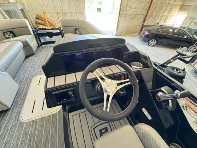 Slide: The Image of 2024 Premier 250 Solaris RL boat interior with steering wheel and control panel. - 14
