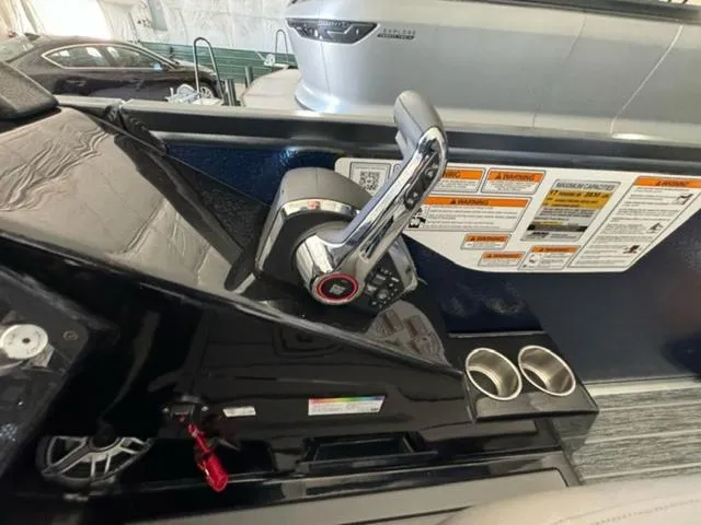 Slide: The Image of 2024 Premier 250 Solaris RL boat control panel with throttle and warning labels. - 15