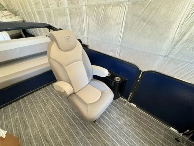 Slide: The Image of 2024 Premier 250 Solaris RL boat interior with captain's chair and cup holder. - 16