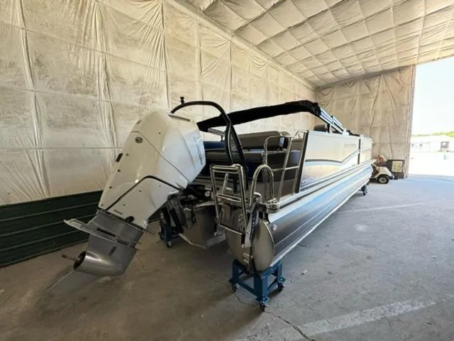 Slide: The Image of 2024 Premier 250 Solaris RL pontoon boat in a storage facility. - 4