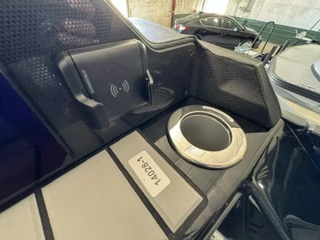 Slide: The Image of 2024 Premier 250 Solaris RL boat interior with wireless charger and cup holder. - 7