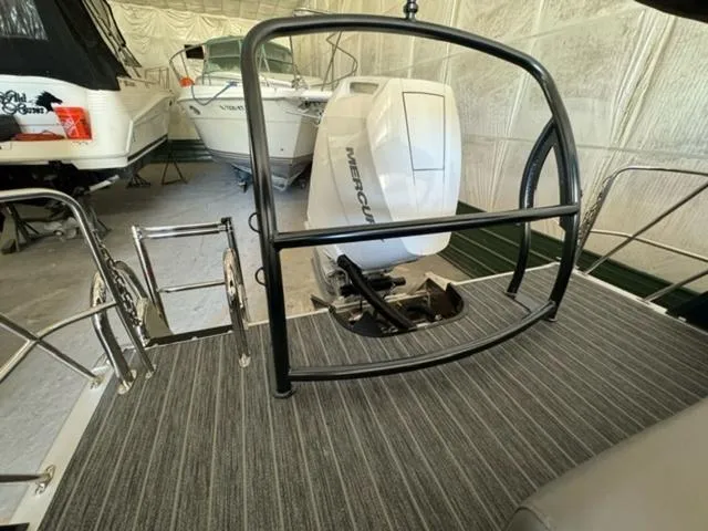 Slide: The Image of 2024 Premier 250 Solaris RL boat with Mercury outboard engine in storage. - 8