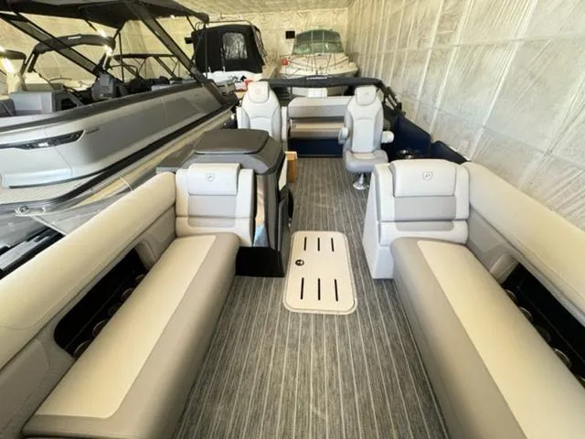 Slide: The Image of 2024 Premier 250 Solaris RL pontoon boat interior with luxurious seating and modern design. - 9