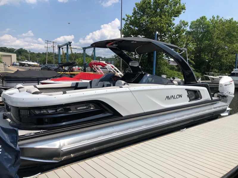 The Image of 2024 Avalon Excalibur 27' pontoon boat docked at marina. - 0