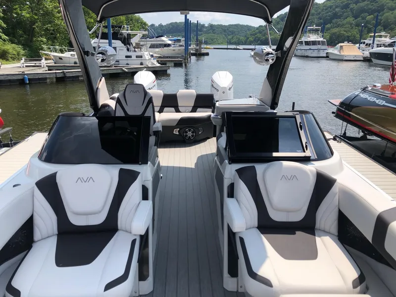 Slide: The Image of 2024 Avalon Excalibur 27' luxury pontoon boat interior at marina. - 12