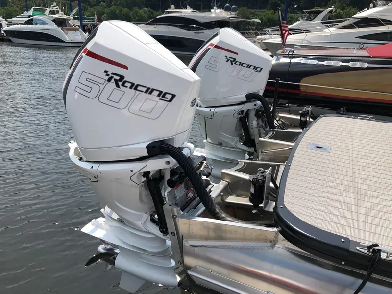 Slide: The Image of 2024 Avalon Excalibur 27' with twin Racing 500 outboard motors at marina. - 4