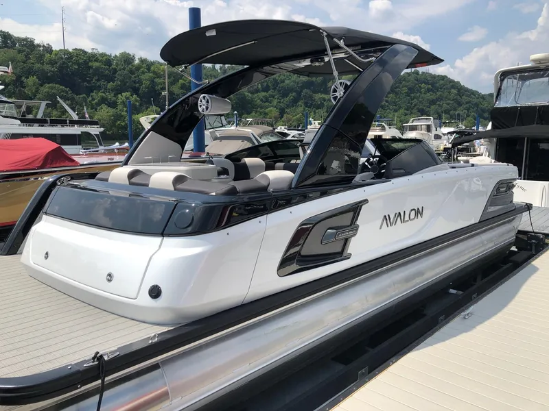 Slide: The Image of 2024 Avalon Excalibur 27' luxury pontoon boat docked at marina. - 6