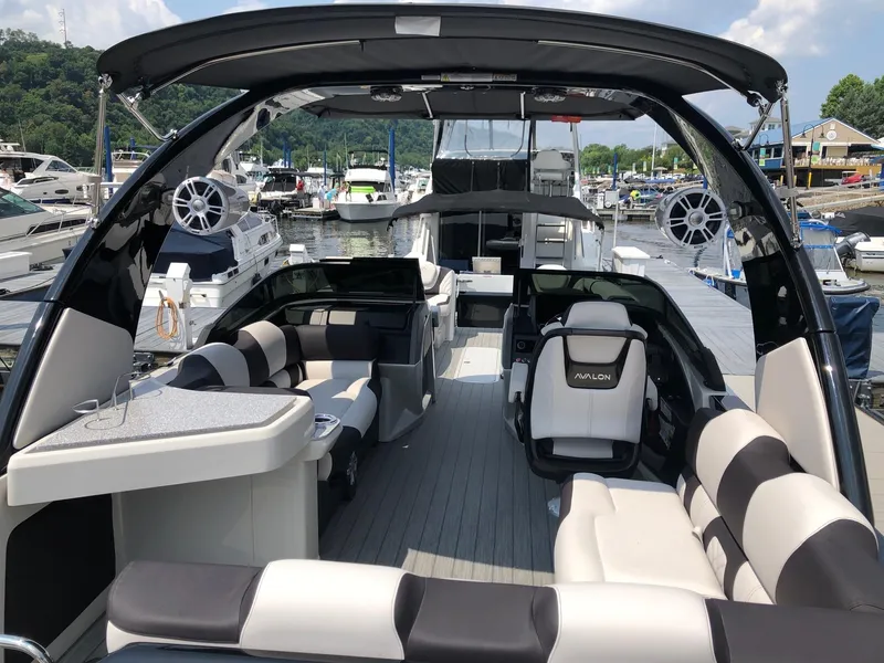 Slide: The Image of 2024 Avalon Excalibur 27' luxury pontoon boat interior at marina. - 7